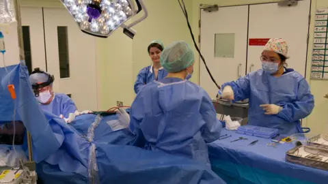 Mark Norman BBC NHS practitioners working within the operating operation of the loads and masks.